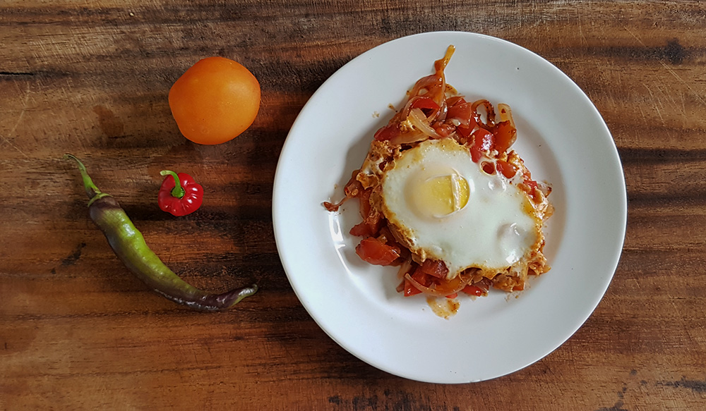 Shakshuka dish on a wood board